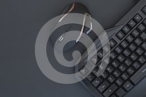 Workspace with a keyboard and mouse on a black background. Copyspace