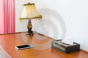 Workspace with mobile phone on wooden table