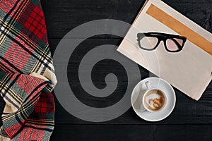 Workspace with newspaper, coffee cup, scarf, glasses. Stylish office desk. Autumn or Winter concept. Flat lay, top view