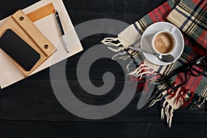 Workspace with newspaper, coffee cup, scarf, glasses. Stylish office desk. Autumn or Winter concept. Flat lay, top view