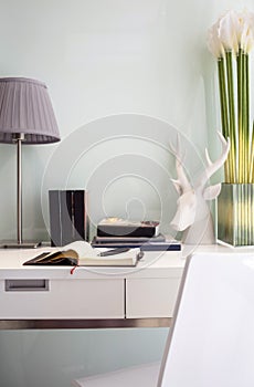 Workspace table with book lamp and chair