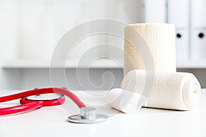 Workspace or workplace in a doctorÃÂ´s office with bandages and a stethoscope photo