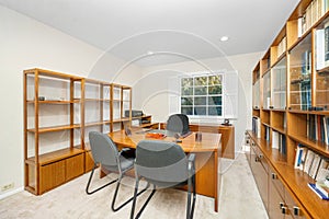 Workstation with desk, chair, and wooden bookshelf in Encino, CA