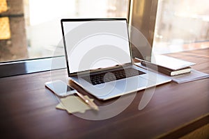 Workstation with open pc laptop computer with blank display background for advertising text message