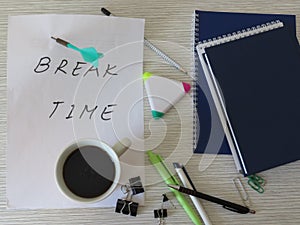 Worktable. Break Time Concept. Relaxation. Office desk table with notebooks, supplies and coffee cup. Top view.