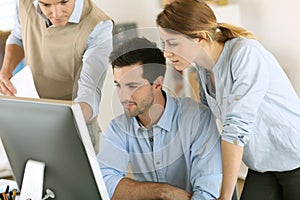 Workteam with computer in office