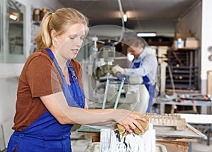 Workwoman cleaning glass