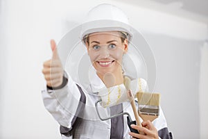 workwoman gives thumbs up in front