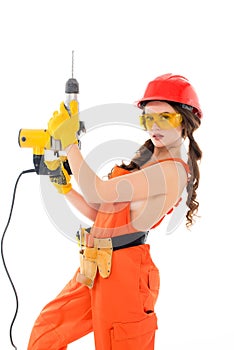 workwoman in overalls and hardhat holding electric drills,