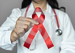 World aids day and national HIV AIDS and ageing awareness month in December with red ribbon on medical