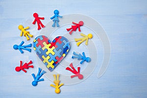 World Autism Awareness day, mental health care concept with puzzle or jigsaw pattern on heart with kids figures photo