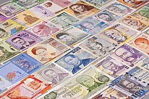 World banknotes displayed in various colors and designs on a table