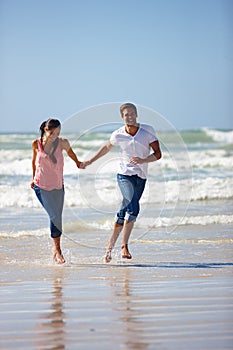 In this world of black and white, youre my colored picture. a young couple being playful on the beach.