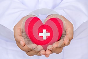 World Blood Donor Day, June 14. Doctor hands holding red heart