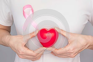 World Breast Cancer Day Concept,health care - woman wore pink t-shirt,Pink ribbon for breast cancer awareness, symbolic bow color