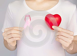 World Breast Cancer Day Concept,health care - woman wore pink t-shirt,Pink ribbon for breast cancer awareness, symbolic bow color