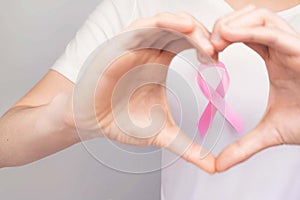 World Breast Cancer Day Concept,health care - woman wore pink t-shirt,Pink ribbon for breast cancer awareness, symbolic bow color