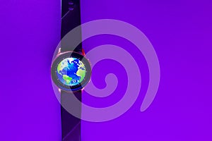 World business Smart Watch on the glowing neon purple,veri peri color background with empty space for your text.Closeup,copy space