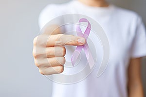 World cancer day February 4. Woman hand holding Lavender purple ribbon for supporting people living and illness. Healthcare and