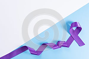 World cancer day  purple ribbon on with and blue background with copy space for text. Healthcare and medical concept