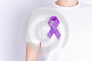 World cancer day  purple ribbon on chest isolated grey background. Healthcare and medical concept