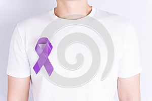World cancer day  purple ribbon on chest isolated grey background. Healthcare and medical concept