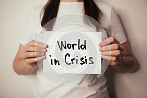 World in crisis - woman hold card with text, social and economic, climate problems concept