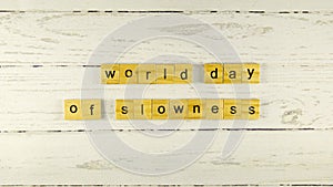 world day of slowness.words from wooden cubes with letters photo