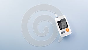 World Diabetes day concept ,14 November. Top view of blood glucose meter sets on pastel blue background