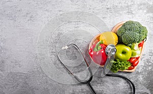 World diabetes day and healthcare concept. Healthy food eating nutrition in plate and stethoscope on stone background