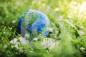 World Earth Day Concept. Green Energy, ESG, Renewable and Sustainable Resources. Environmental Care. Globe Lay on Grass