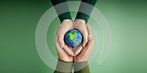 World Earth Day Concept. Green Energy, ESG, Renewable and Sustainable Resources. Environmental Care. Hands of People  Embracing a
