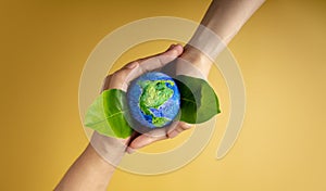 World Earth Day Concept. Green Energy, ESG, Renewable and Sustainable Resources. Environmental and Ecology Care. Hands of People photo