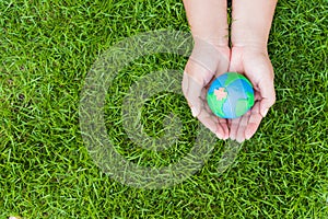 World Earth Day concept. Woman hand holding handmade globe