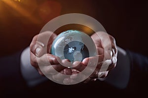 world, earth, planet, business concept glass earth globe in the hands