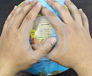 World environment day concept: hands touching globe