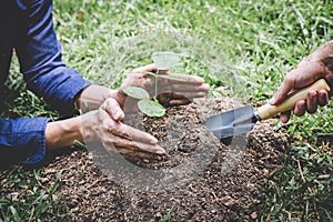 World environment day reforesting, Hands of young man helping were planting the seedlings and tree growing into soil while working