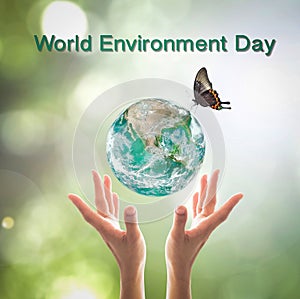 World environment day, sustainable ecology and environmental friendly concept with green earth planet on volunteer`s woman hands.