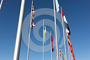 World flags hanging still on a calm blue day