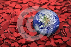 World globe on hundreds of small red hearts photo