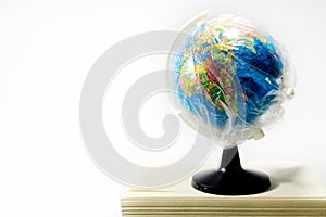 World globe in isolation under plastic cover covid-19 worldwide pandemic.