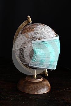 World globe with a mask to protect agains corona virus