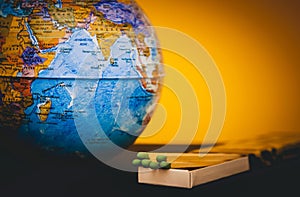 World globe and matches on a tinted yellow background, the concept of saving the planet from fire, save the earth