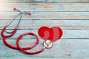 World health day, healthcare and medical concept, red stethoscope and red heart on the blue wooden background