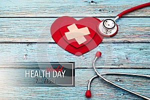 World health day, healthcare and medical concept, red stethoscope and red heart on the blue wooden background