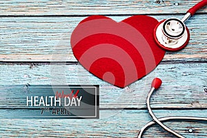 World health day, healthcare and medical concept, red stethoscope and red heart on the blue wooden background