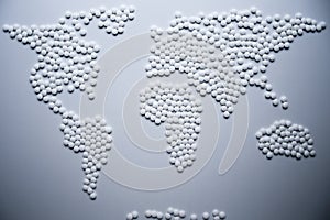 World health map concept created from white tablets urgently needed to cure the whole world