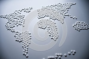 World health map concept created from white tablets urgently needed to cure the whole world