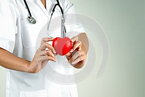 World heart day concept of woman doctor hand holding red heart