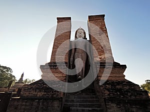 A World Herritage Buddha in Thailand with a sun set and silhouette